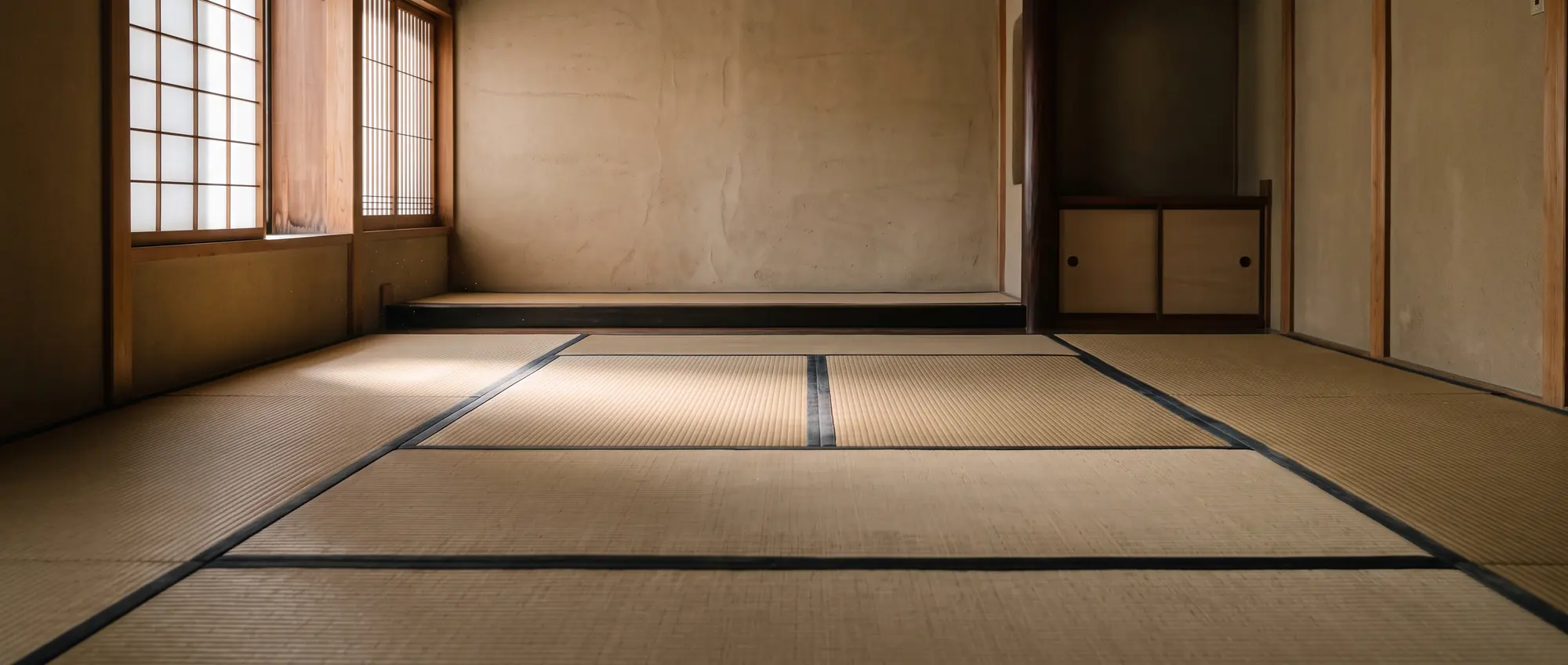 An empty tatami room, morning light through a shoji screen.